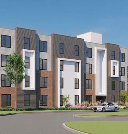 A modern apartment building with a green design on the side.