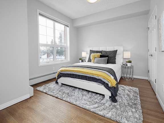 a bedroom with a bed and a window