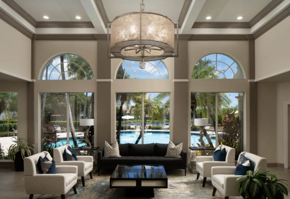 a large lobby with couches and chairs and a swimming pool