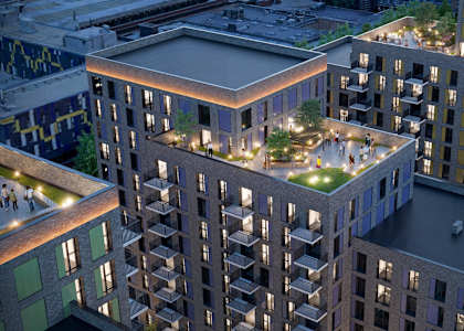 A modern building complex with a green roof at the center.