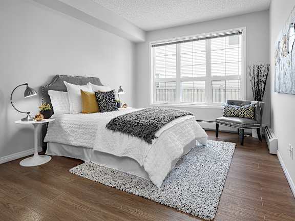 an apartment bedroom with a bed and a window