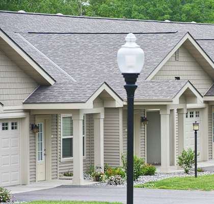 A row of houses with a street light in front.