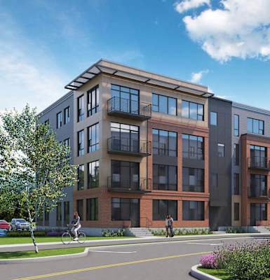 A modern apartment complex with a mix of brick and panel exterior walls.