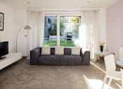 Thumbnail 4 of 5 - a living room with a couch and a window