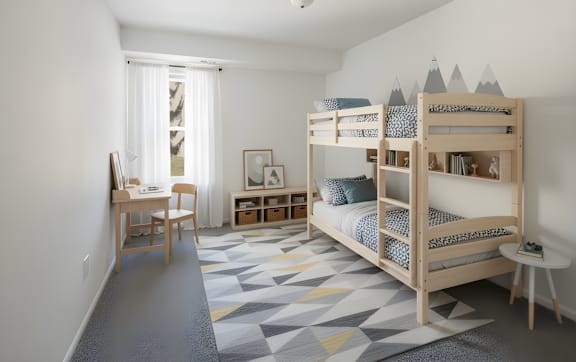 A room with a bunk bed and a desk.