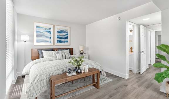 A bedroom with a large bed and a wooden coffee table.
