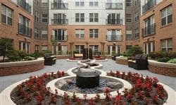 a fountain in a courtyard in front of an apartment building