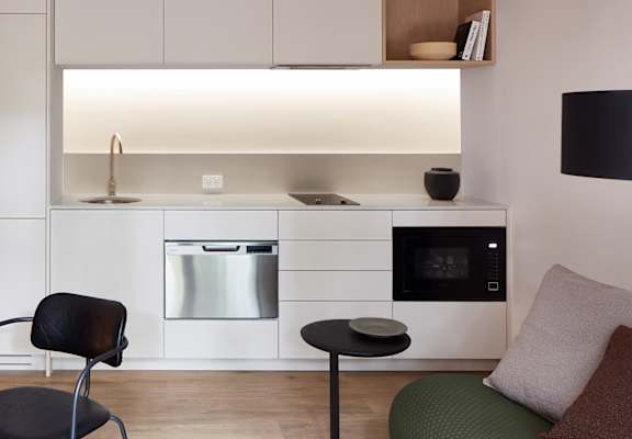 a kitchen and living room with a table and chairs