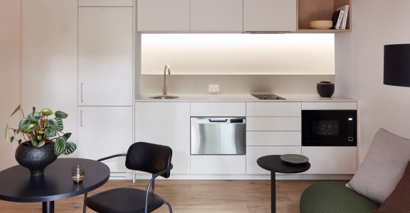 a kitchen and living room with a table and chairs