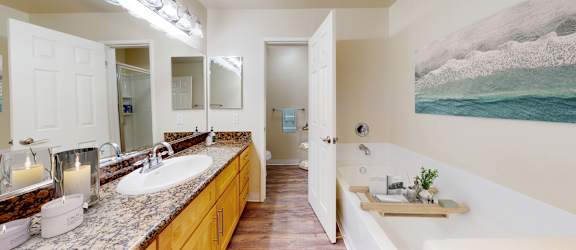 A bathroom with a large mirror and a tray with toiletries on it.