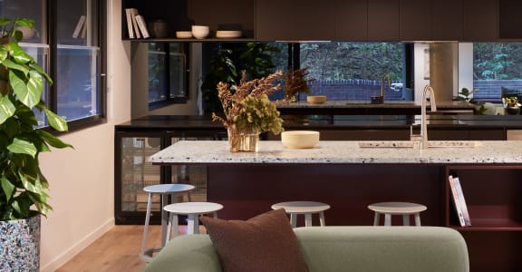 a kitchen with a marble counter top and a bunch of stools