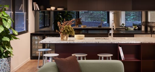 a kitchen with a marble counter top and a bunch of stools