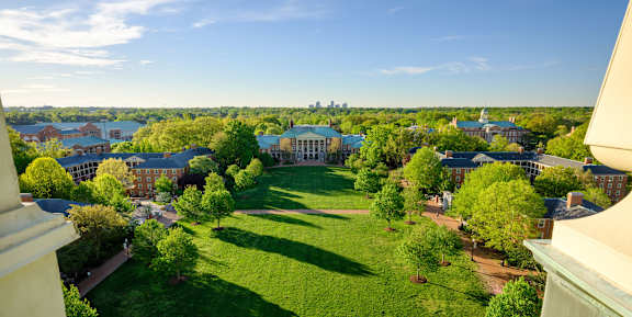 Wake Forest University campus in Winston-Salem NC near Sugar Creek Apartments with green quad, academic buildings, and skyline views.