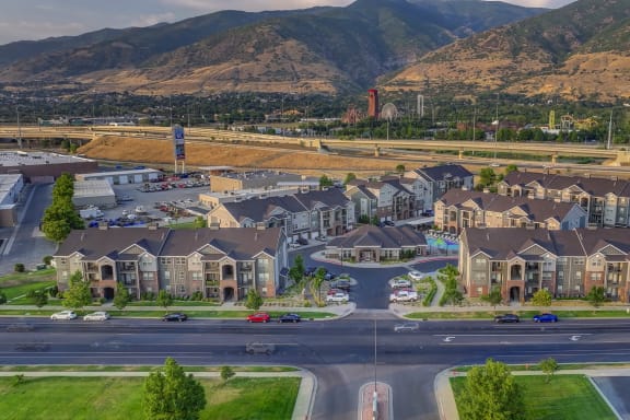 an aerial view of a neighborhood of houses with mountains in the background