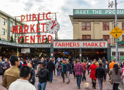 people walking in front of the public market center in seattle