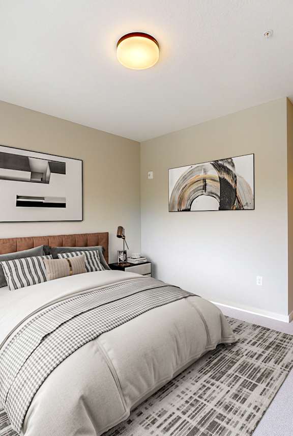 A bedroom with a large bed and a mirror on the wall.