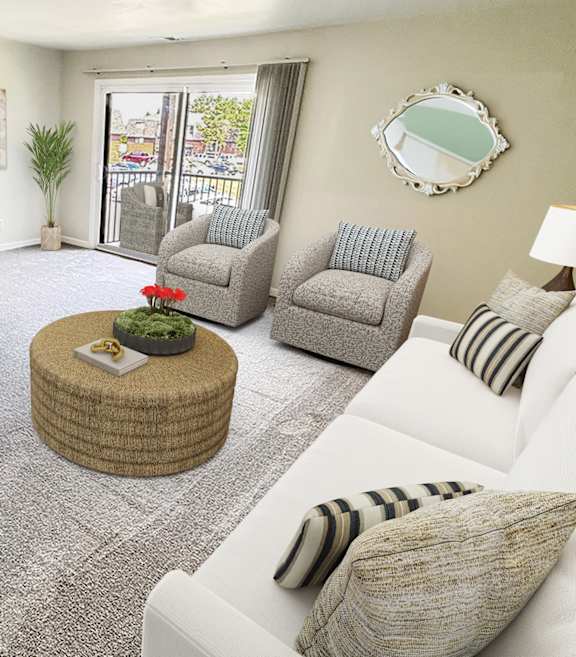 A living room with a white couch, grey chairs, and a wooden coffee table.