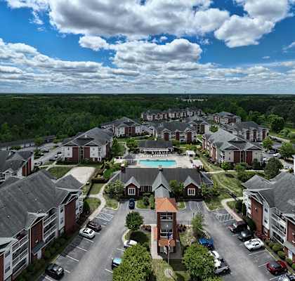 A large apartment complex with a swimming pool in the center.