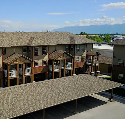 A row of houses with a large roof.