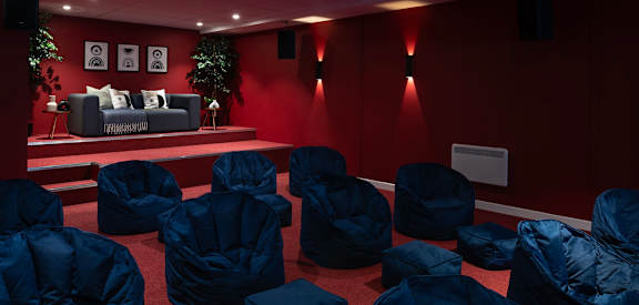 a room filled with chairs covered in blue plastic