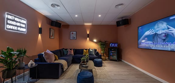 a living room with couches and a tv on the wall