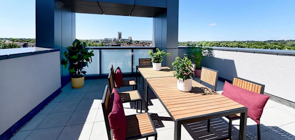 a roof top terrace with a wooden table and chairs
