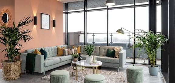 a living room with couches and tables and a large window