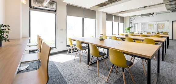 a large conference room with tables and chairs