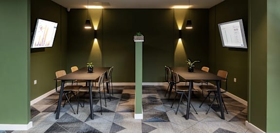 a dining room with tables and chairs and green walls