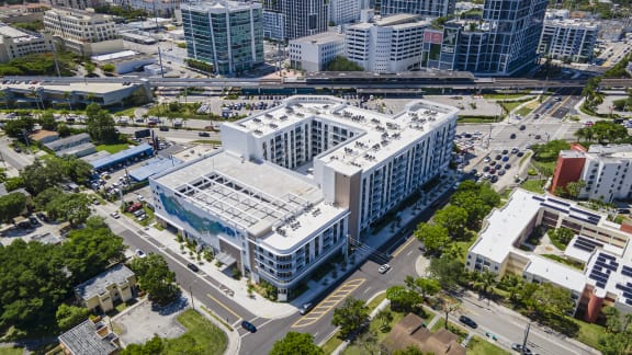 an aerial view of a large white building with a glass roof