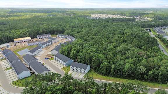 A bird's eye view of a resort surrounded by trees.