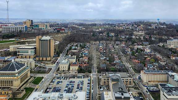 A cityscape with buildings and a parking lot.