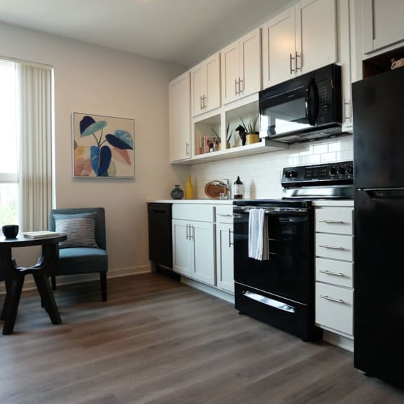 a kitchen with a white table and orange stools