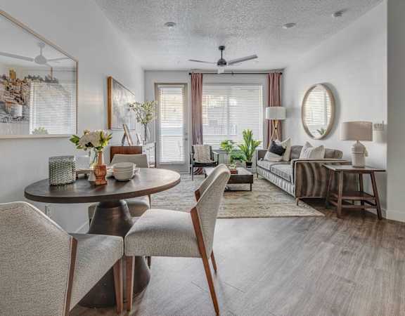 A dining room with a round table and chairs.