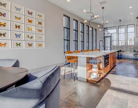 A modern kitchen with a long island and a dining area.