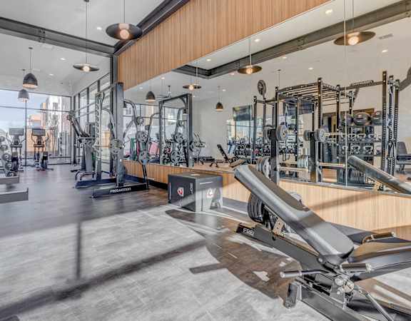 A gym with a variety of equipment including a rowing machine.