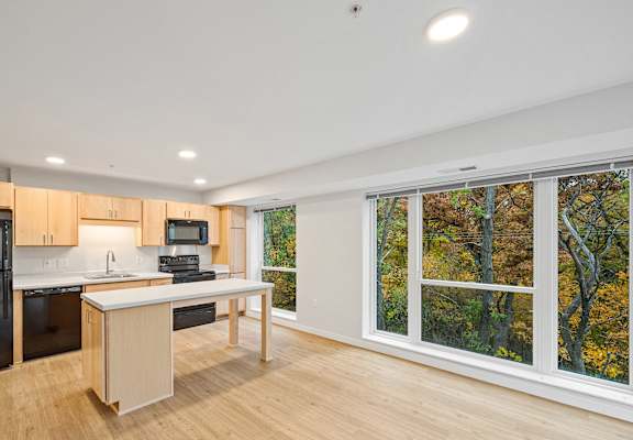 a kitchen with a large window and a island with a counter top