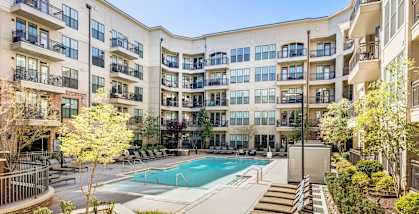 a swimming pool in front of an apartment building