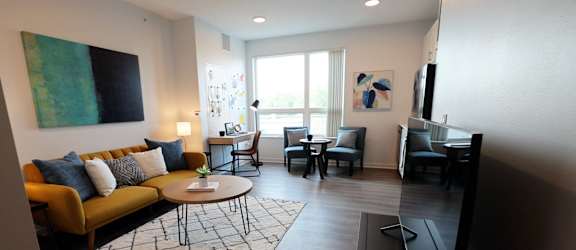a living room and dining room with a couch and a table