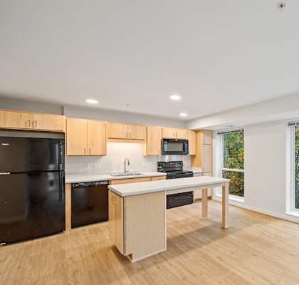 a kitchen with a large window and a island with a counter top