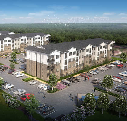 A large apartment complex with a parking lot in front.