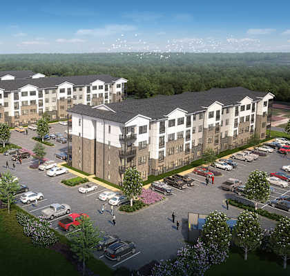 an aerial view of an apartment complex with a parking lot