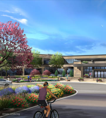 a rendering of a building with a person riding a bike in front of it