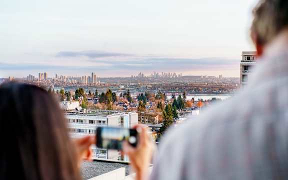A person is taking a photo of a cityscape.