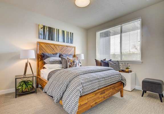 a bedroom with a bed and a window