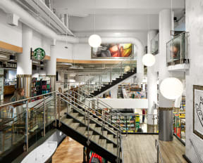 the interior of a bookstore with a staircase and bookshelves