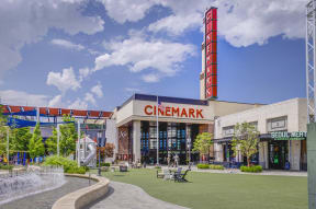 a building with a cinemark sign in front of a fountain
