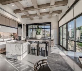 a kitchen with a large island with a marble countertop