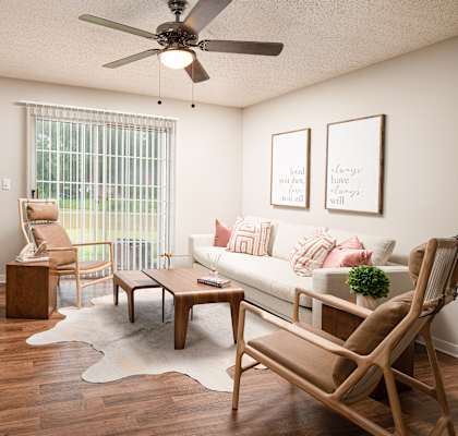 A living room with a couch, chair, and table.