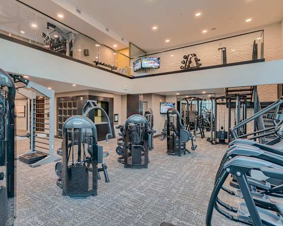 a gym with cardio machines and weights in a building